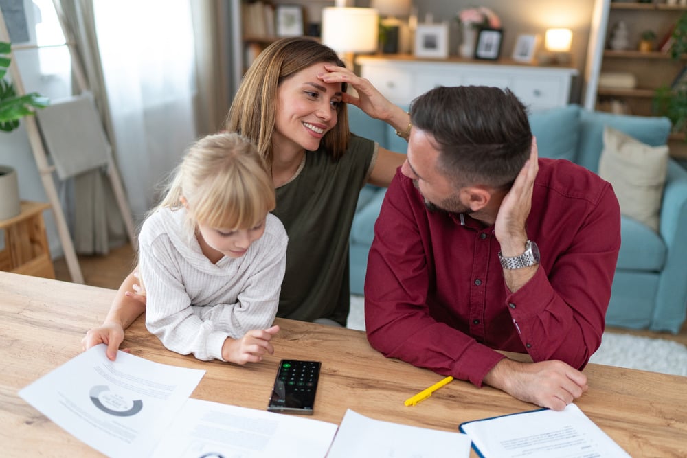 Happy family paying bills at home