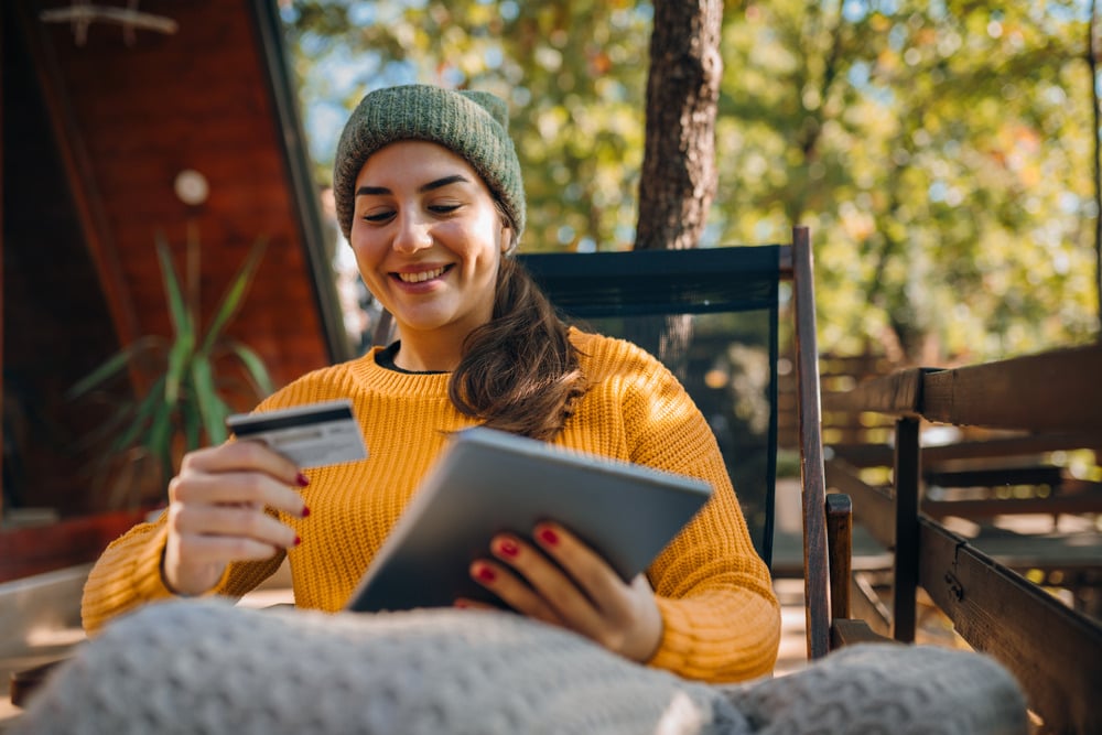 Young woman using a digital tablet on a sunny autumn day